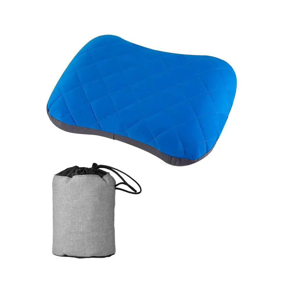 A blue inflatable ultralight camping pillow with a quilted pattern, paired with a compact gray drawstring carry bag, displayed against a white background.
