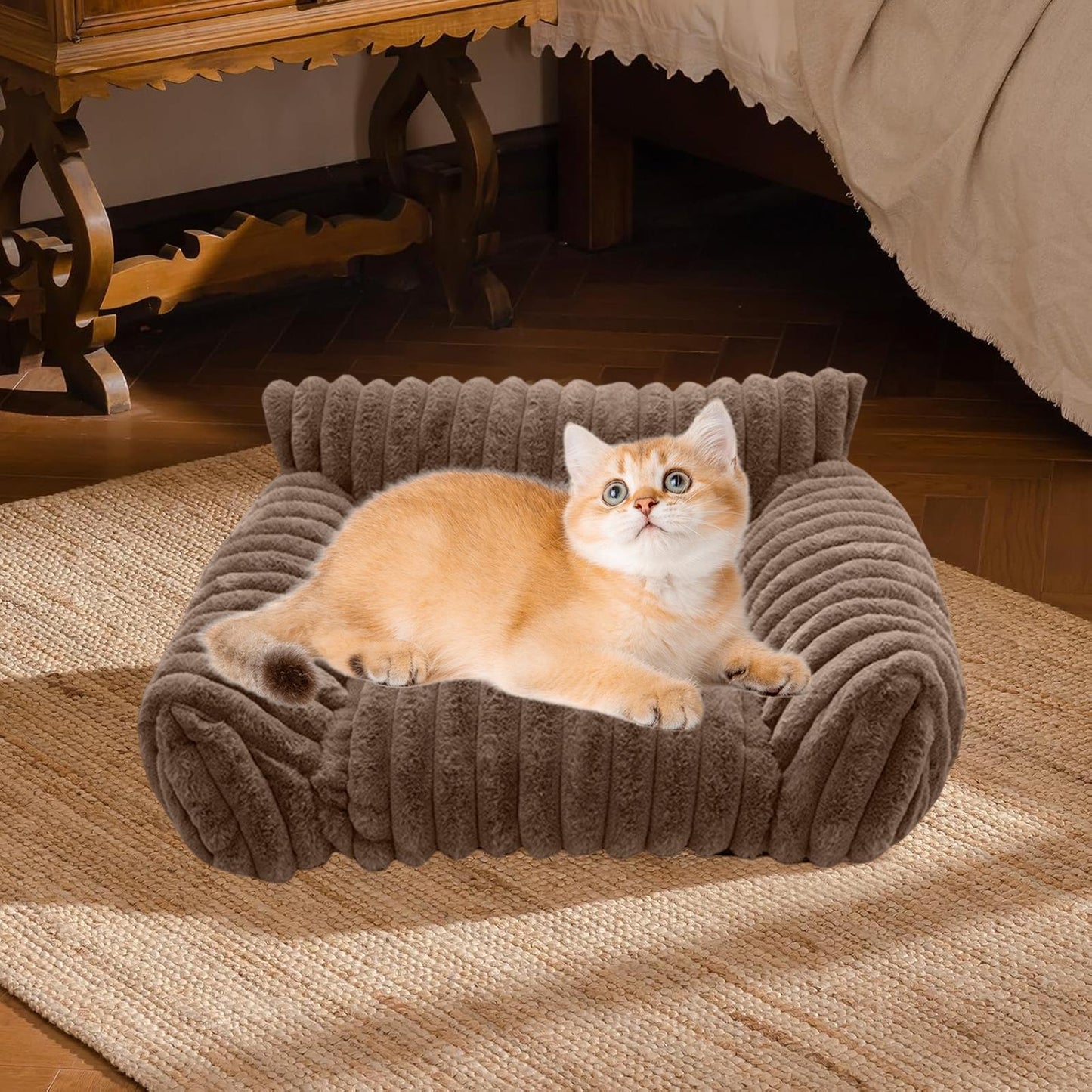 Cat lying on a plush brown pet bed in a cozy room.