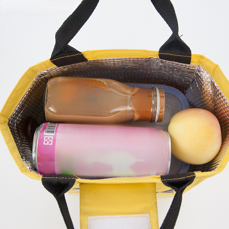 Top view of an insulated Yellow lunch bag filled with a drink bottle, soda can, and fruit in a white background.
