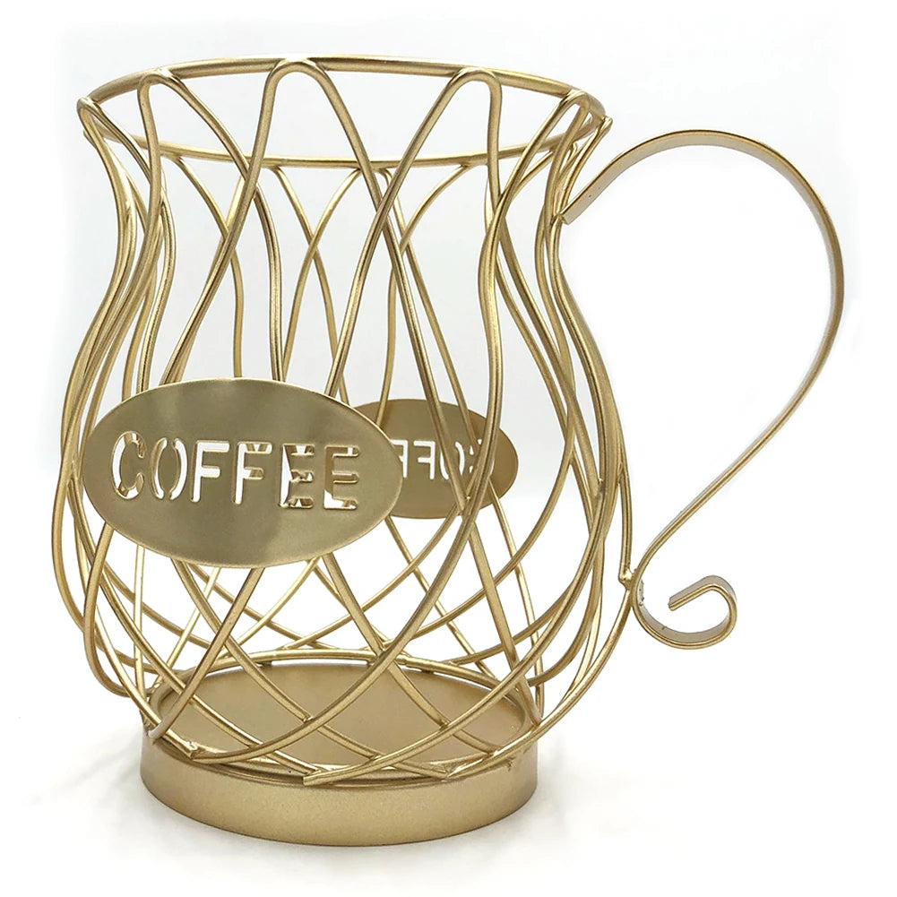 A gold iron wire coffee capsule storage basket shaped like a coffee cup, featuring a twisted metal design with a "COFFEE" cutout on an oval metal plate and a curved handle.