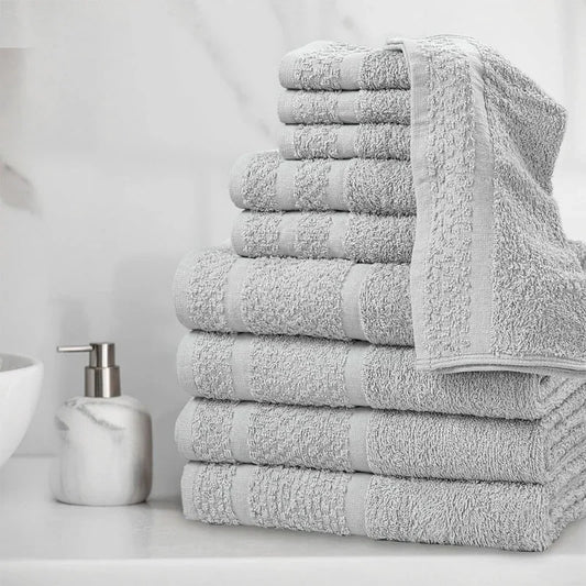 10 Piece Stack of gray towels of different types on a bathroom counter with a soap dispenser.
