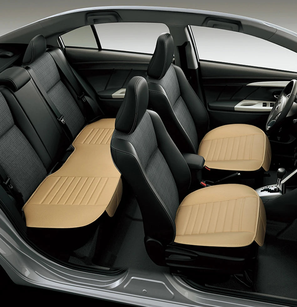 car interior showing beige backless seat cushions on both front seats and a full-width beige bench cushion in the rear, low-profile fit on dark upholstery