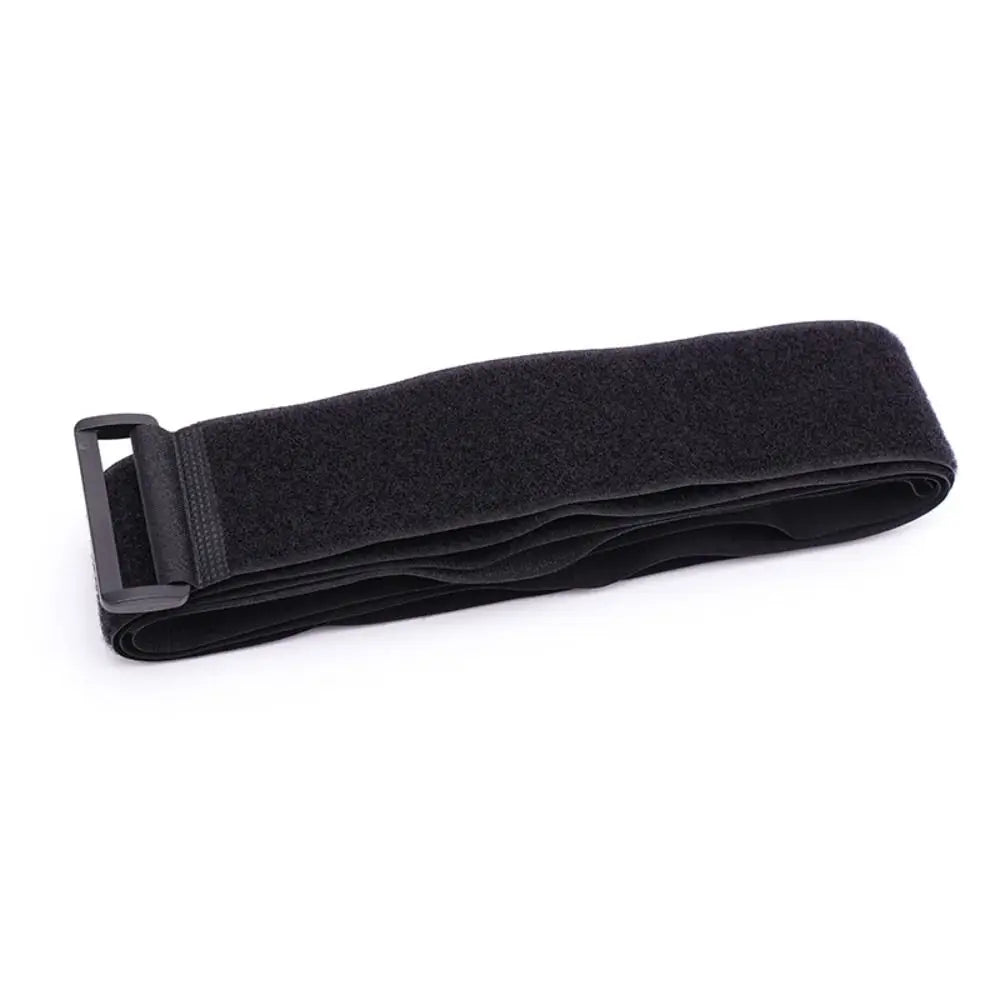 Folded black adjustable luggage strap with buckle made from nylon and hook-and-loop fastening.