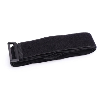 Folded black adjustable luggage strap with buckle made from nylon and hook-and-loop fastening.
