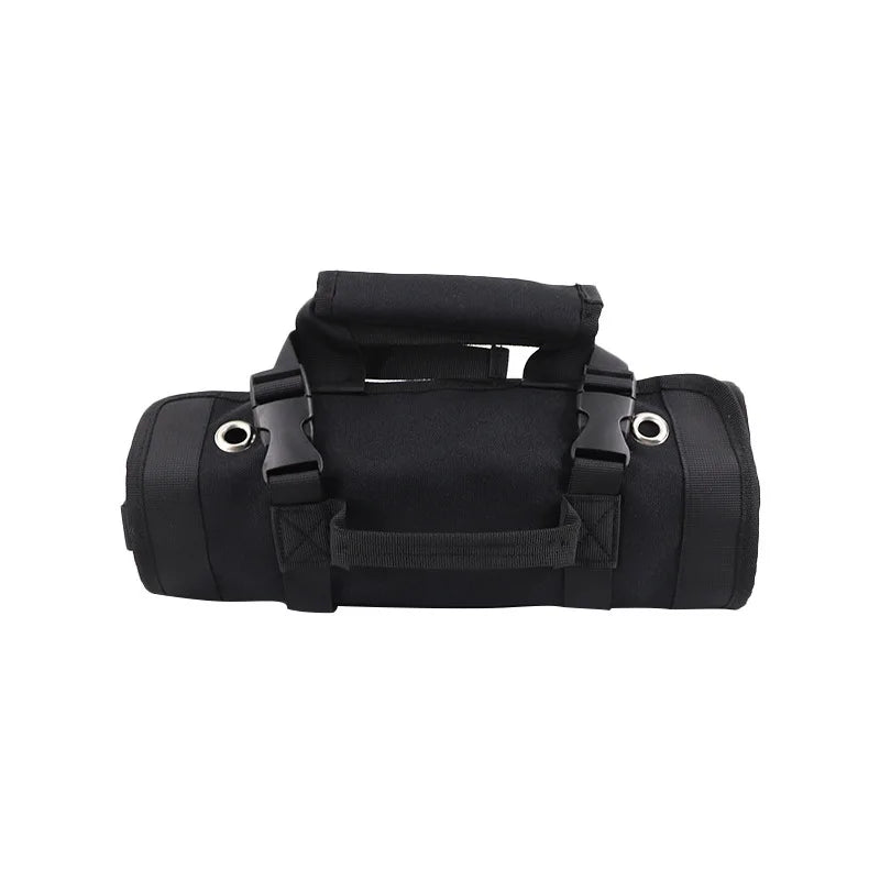 Rolled-up black tool roll organizer with padded handle, buckle straps, and metal grommets for hanging, designed for easy transport and secure storage.