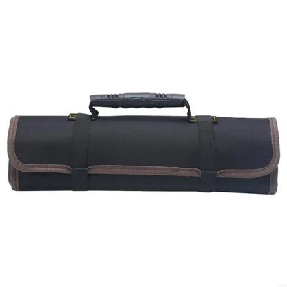 Black tool roll bag shown horizontally in rolled-up position with a sturdy molded handle, brown trim, and black straps. Designed for storing tools securely during transport.