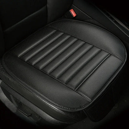 black perforated leather car seat cushion with ribbed stitching installed on the seat base; backless design keeps controls and backrest clear