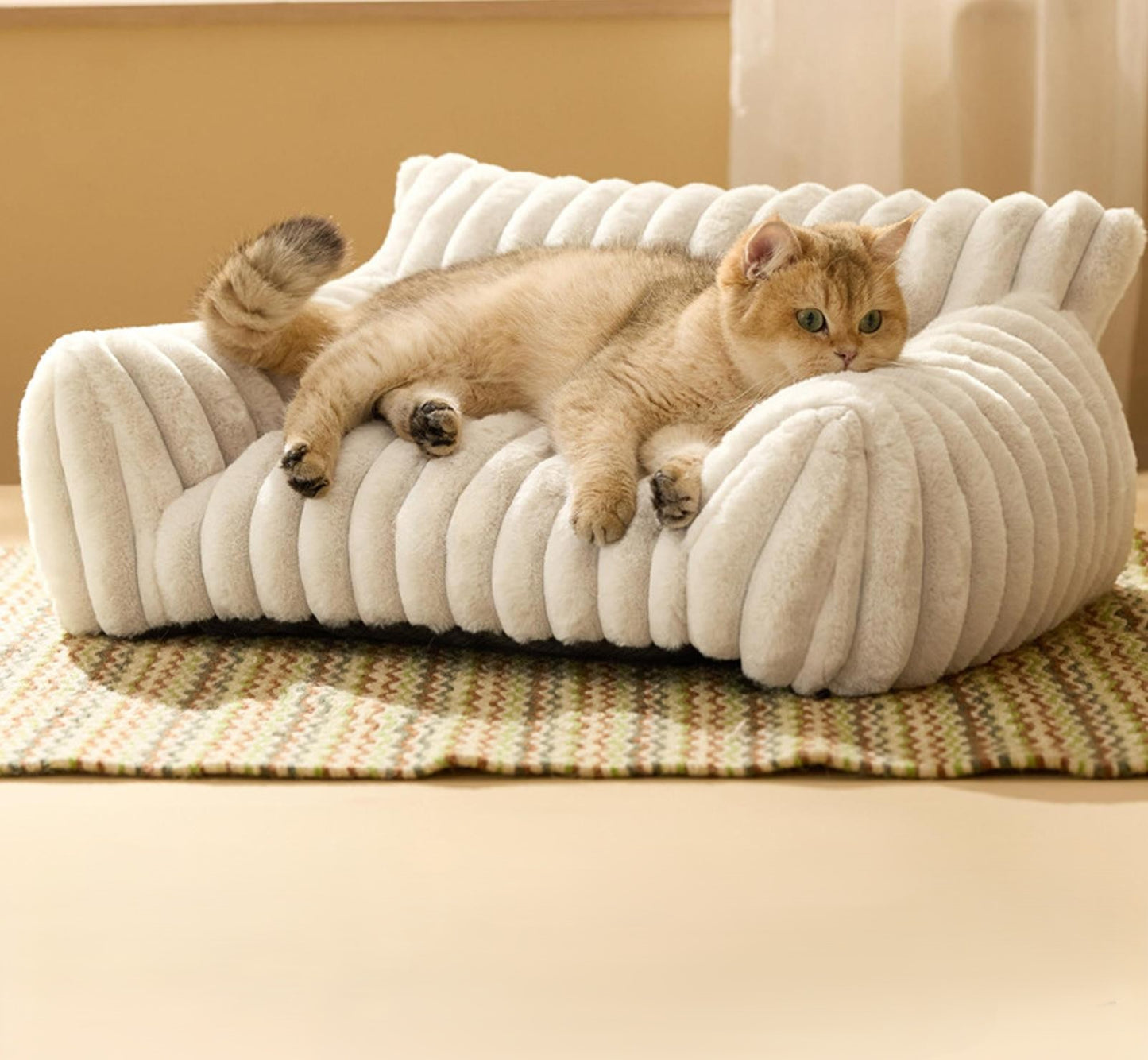 Cat lying on a plush, white pet bed in a cozy room.