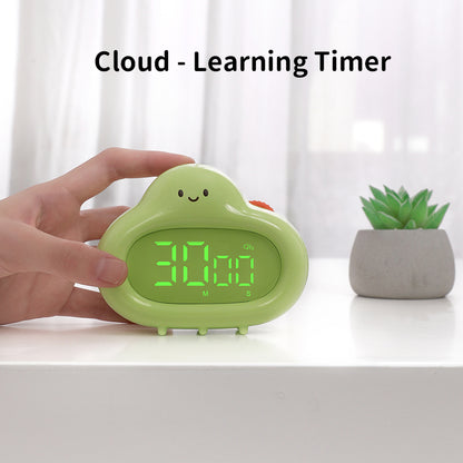 A person’s hand is shown holding the green cloud timer on a white desk. The LED display reads “30:00,” and the text “Cloud – Learning Timer” appears above the product. A small green succulent plant is blurred in the background.
