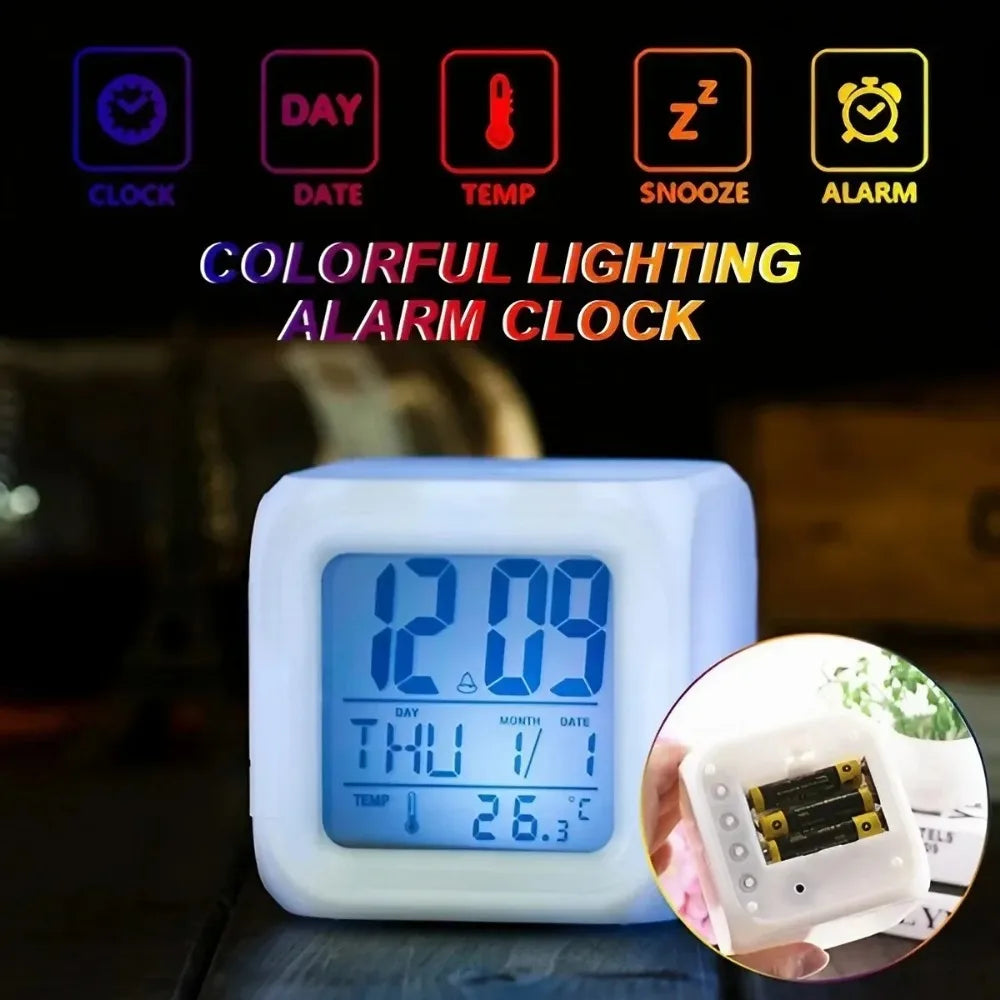 A white LED cube alarm clock with blue backlight on a dark surface; icons above illustrate functions like clock, date, temperature, snooze, and alarm; inset displays battery slots.