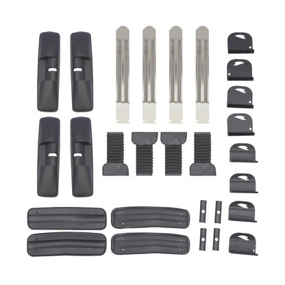 flat-lay of roof rack components: four clamp housings, four stainless tension straps, rubber sleeves and base pads, end caps and spacers for installing a pair of cross bars