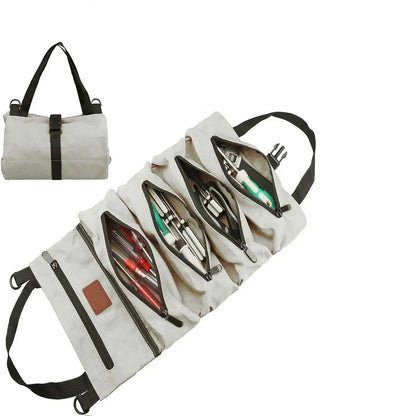 Light gray canvas tool roll bag shown unrolled with tools organized in zippered compartments, and rolled up with black carry handles.