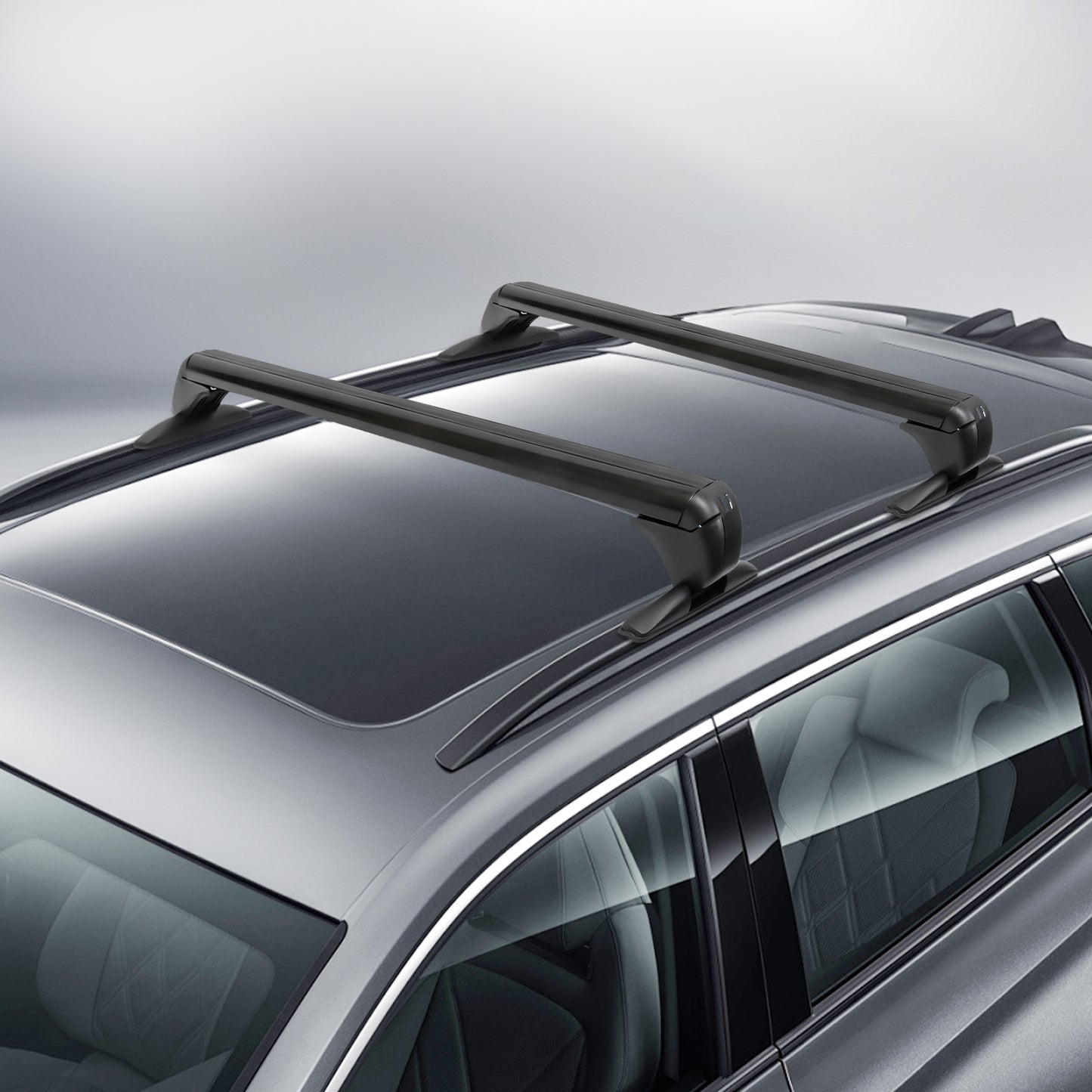 angled view of two black aluminum aerodynamic cross bars clamped at the door frames on a gray SUV roof with panoramic glass; low-drag shape and padded feet visible