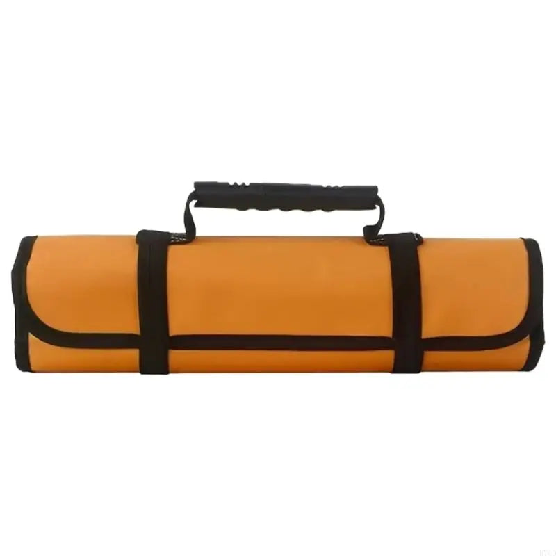 Horizontal view of a rolled-up mustard yellow tool roll with black straps and a molded carrying handle, highlighting its compact and travel-ready design.