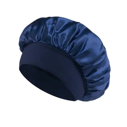 Navy blue satin sleep bonnet with wide soft band for hair protection on a white background