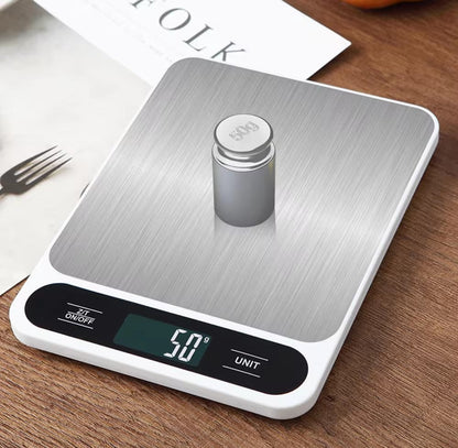 Digital kitchen scale with a small container on a wooden surface