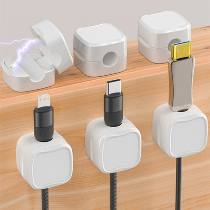 White Magnetic suction cable holder for desktops, cars, and home use. Strong magnetic grip, easy adhesive installation, and compact design for organizing charging cables and USB cords.