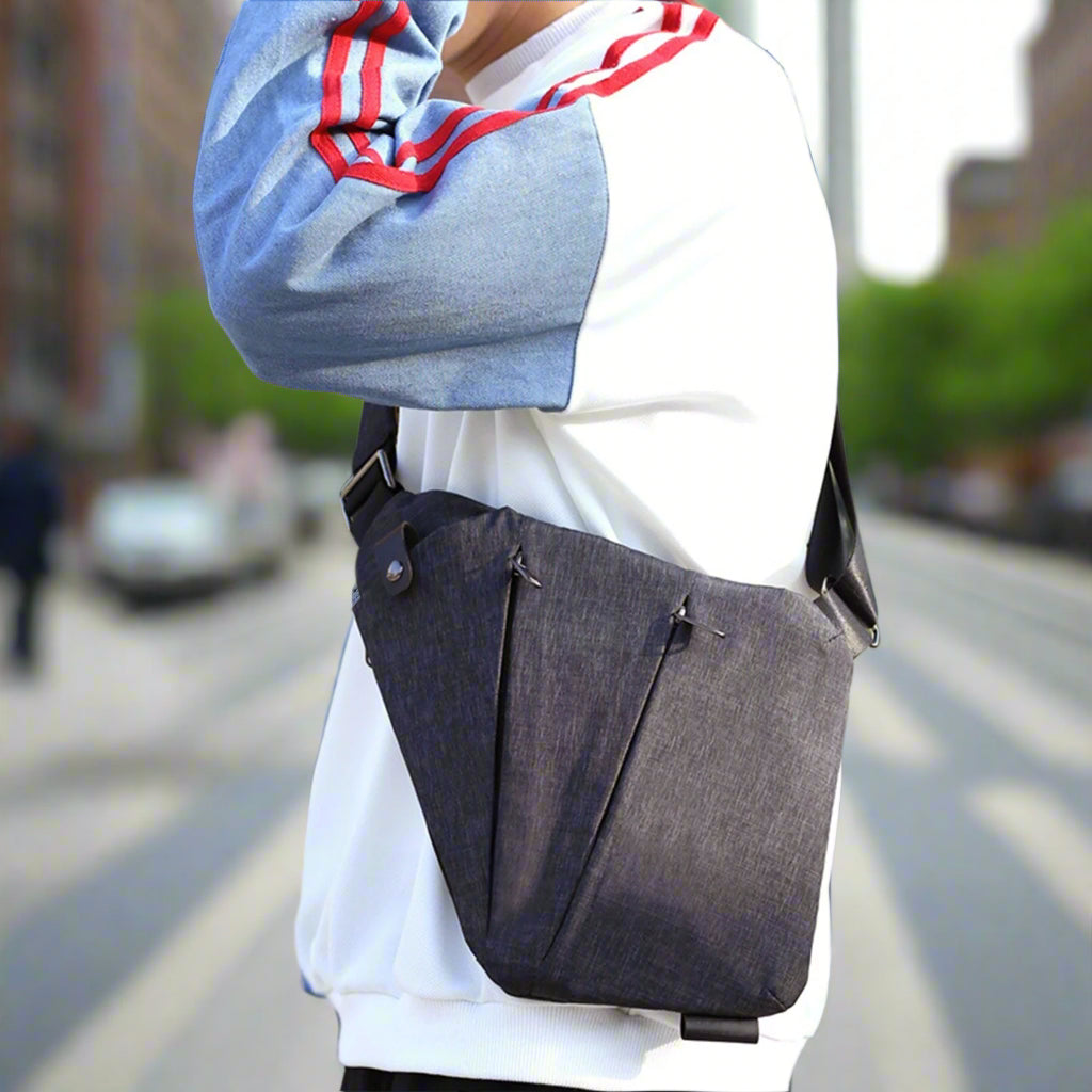 Chest sling bag shown in side profile view worn over the shoulder outdoors