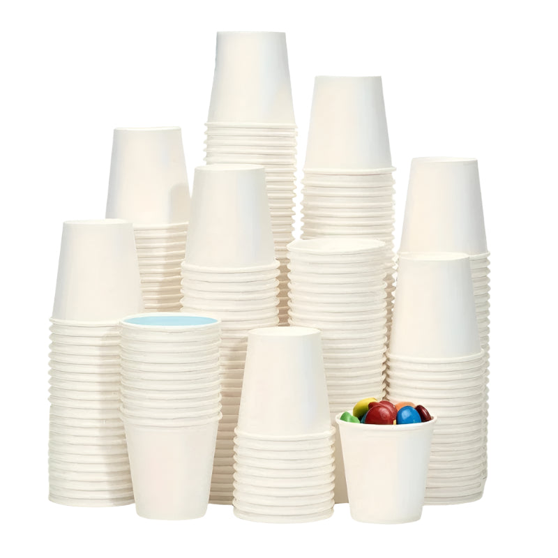 Stacks of white paper cups with a small container holding colorful items on a white background.