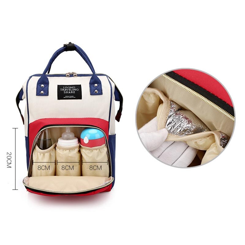 Red, white, and blue diaper backpack showing insulated bottle pockets holding baby bottles and sippy cup.