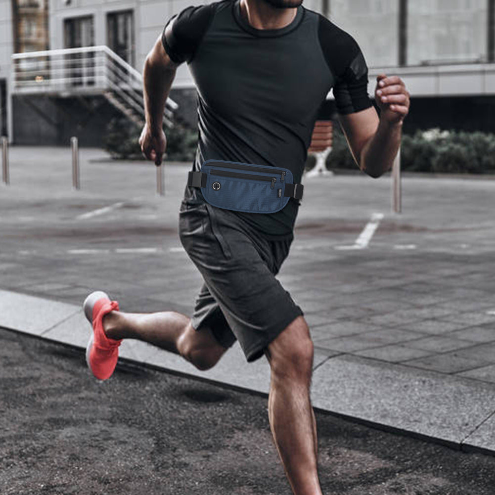 Man running in an urban environment while wearing a dark blue waist pack, highlighting its functionality for fitness and city use.