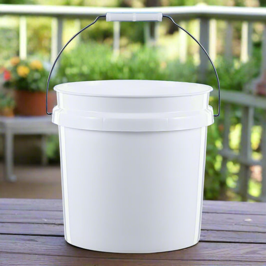 White bucket with a handle on a wooden surface outdoors