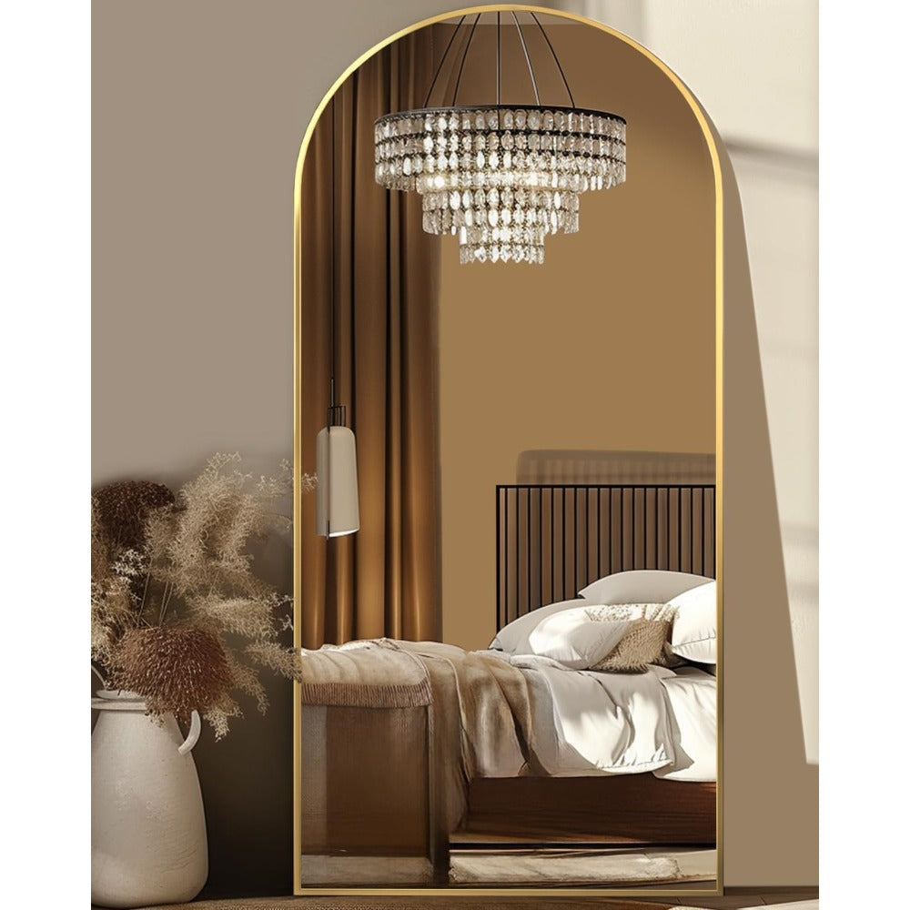 Elegant arched full length mirror with gold frame in a bright living room