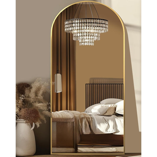 Elegant arched full length mirror with gold frame in a bright living room
