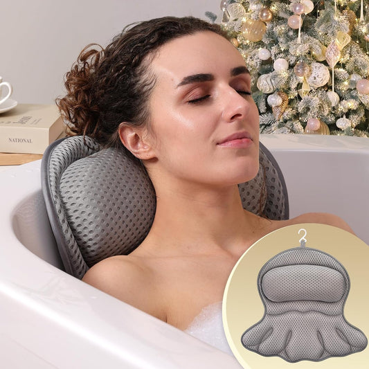 Person relaxing in a tub using a gray bath pillow for head and neck support.