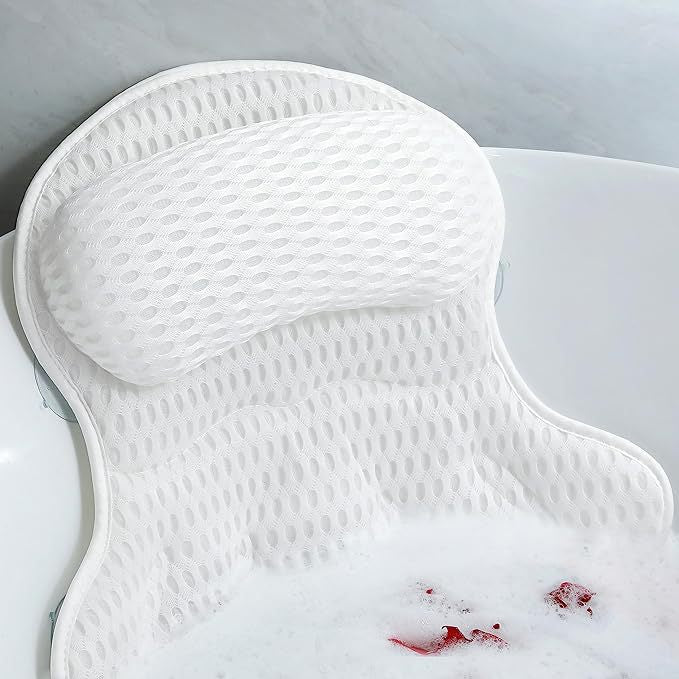 White bath pillow resting inside a bathtub with foam.