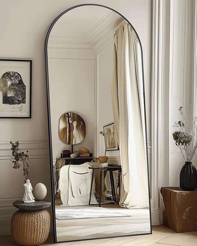 Arched mirror with black frame in minimal boho-chic interior design