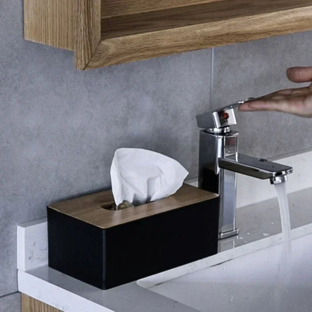 black tissue box with bamboo lid by bathroom sink