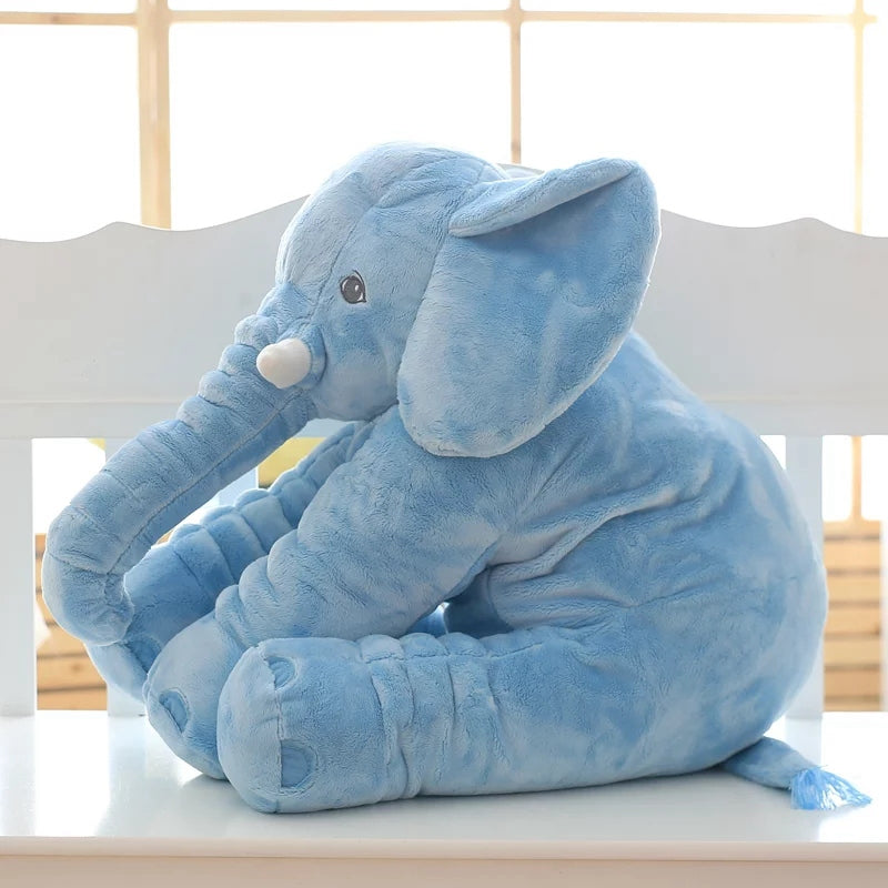 Blue elephant plush toy displayed on chair near window