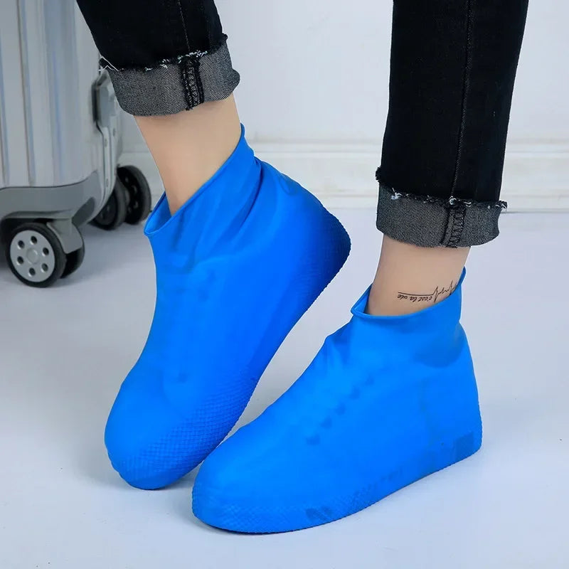 Blue silicone waterproof shoe covers on model's feet