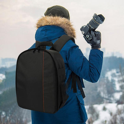 Person wearing camera backpack outdoors with DSLR