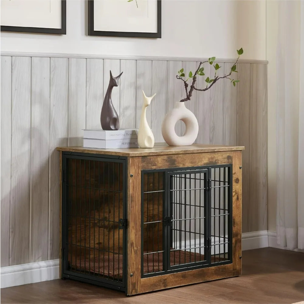 Angled side view of a rustic wooden dog crate with black steel bars, shown as an elegant side table in a well-lit living room. The crate features a front-opening double door, a soft interior mat, and a decorative tabletop with modern ceramic sculptures and books.