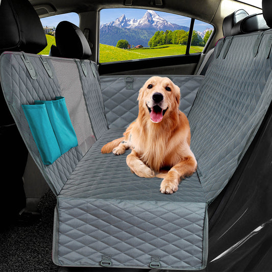 Happy golden retriever relaxing on quilted gray waterproof dog car seat protector.