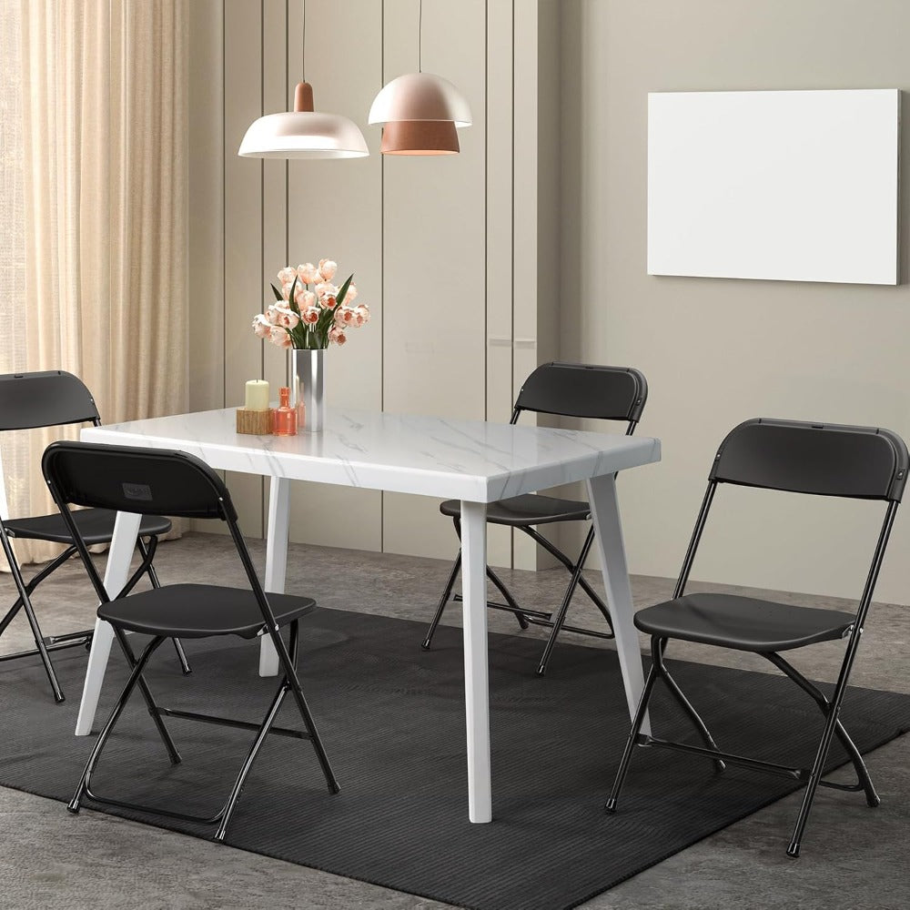 Black folding chairs arranged around a dining table in a modern room