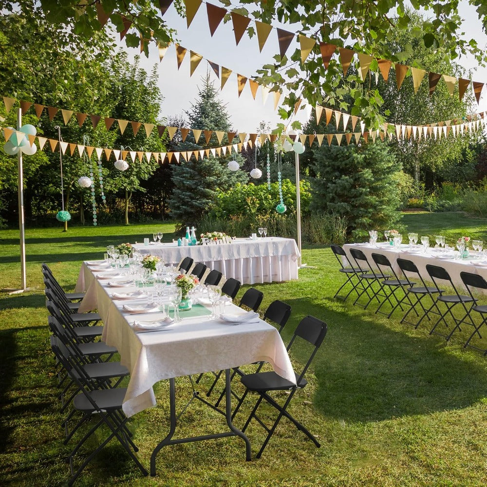 Outdoor garden party setup with rows of black folding chairs and dining tables