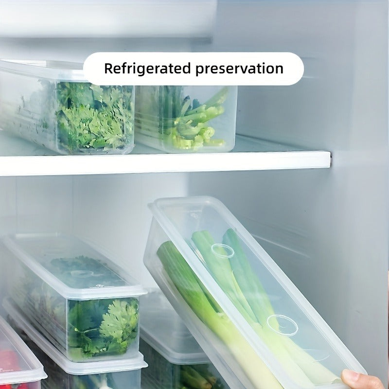 Several long plastic containers with snap lids are neatly stored in a refrigerator. One hand is placing a container filled with green onions inside, demonstrating refrigerated preservation. Other containers hold herbs and green vegetables.