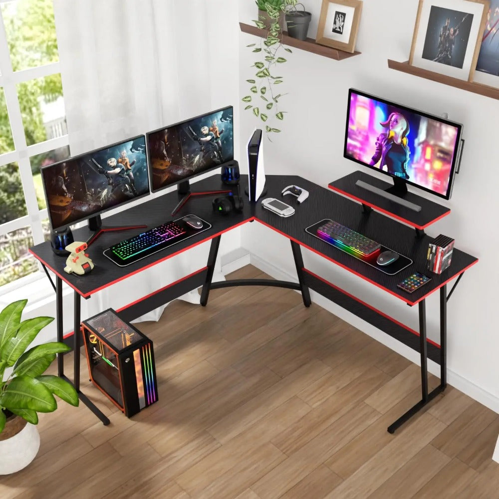 Gaming desk with RGB setup in a sunlit room featuring plants and wall decor.