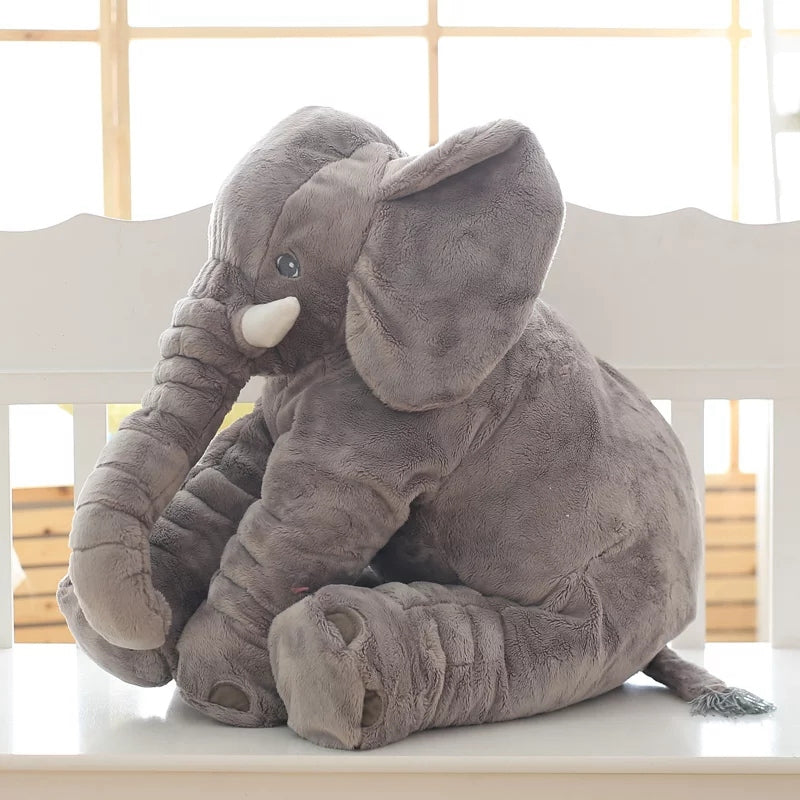 Gray elephant plush toy on chair in bright room