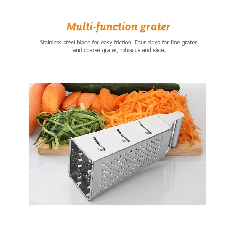 Four-sided stainless steel grater lying on its side in front of freshly grated vegetables, showcasing slicing and grating capabilities.