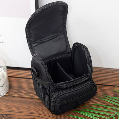 Open waterproof camera shoulder bag showing the padded and compartmentalized interior for storing DSLR or mirrorless camera gear and accessories.