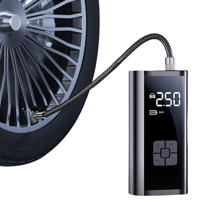 Compact electric air pump inflating a car tire with digital display showing pressure