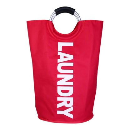 A front-facing image of a bright red cylindrical laundry hamper with the word "LAUNDRY" printed in large white vertical text, featuring silver ring handles with black padding, placed against a plain white background.