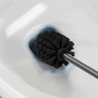 Close-up of silicone toilet brush cleaning a toilet bowl