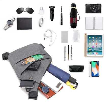 Gray crossbody sling bag displayed with common daily items including phone, wallet, camera, tablet, pen, charger, watch, and umbrella to show maximum storage potential.